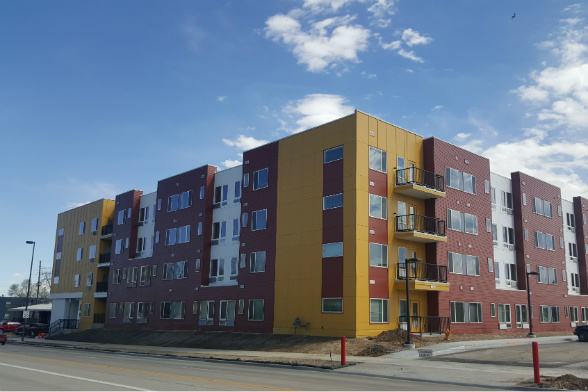 The four-story building includes 114 one- and two-bedroom units.