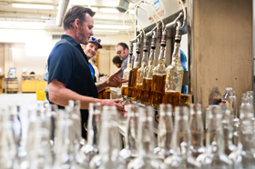 Stranahan's head distiller, Rob Dietrich, fills bottles with whiskey. He can fil up to 19 bottles per minute.