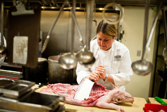 Panzano's Executive Chef Elise Wiggins takes out the ribs of a pig.