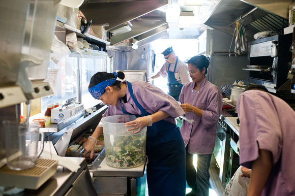 The inside of the Manna from Heaven food truck bustles with cooking activity.