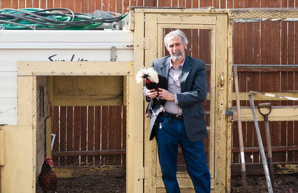 James Bertini poses with one of his chickens.