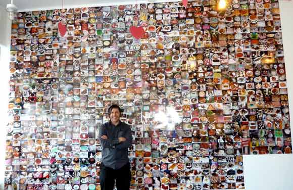 Novick in front of "Sweet Tooth: Photos of 1000 Desserts (that I ate)" at The Shoppe.