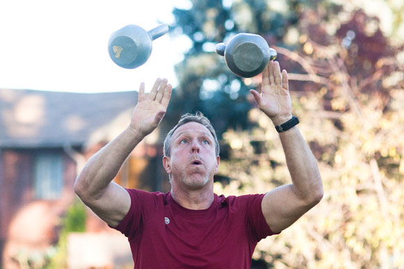 Gus Petersen juggles kettlebells, and teaches his clients to do the same. 