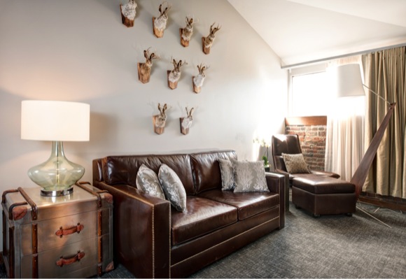 Jackalope taxidermy handpicked by NINE dot ARTS decorates a room at The Crawford Hotel.