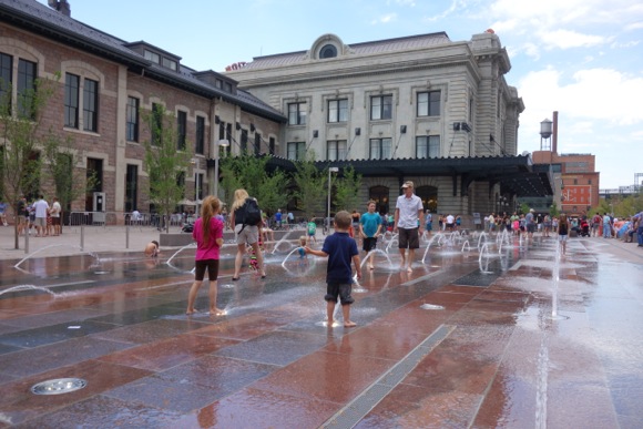 Kids frolic in the new fountains on opening day.
