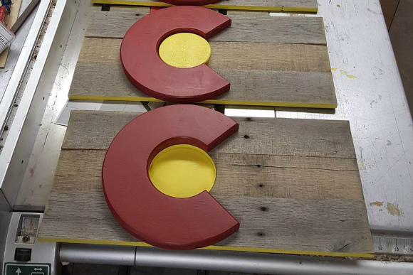Artist Andrew Darr upcycles pallet wood into Colorado state flags.