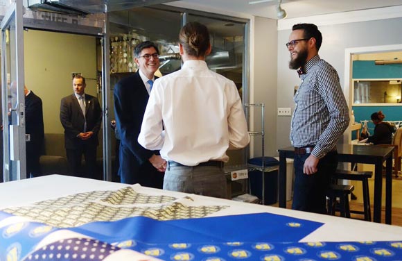 Treasury Secretary Jack Lew speaks with co-founders Mark Johnson, right, and Jeremy Priest.