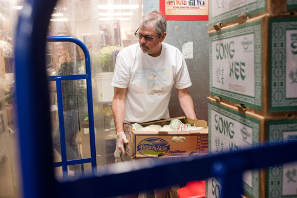 George Mayfield picks up food at Sprouts while volunteering with Denver Food Rescue.