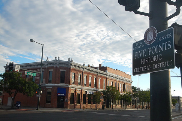 A sign hangs in front of the Atlas Drug building.