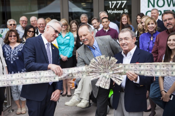 Officials cut the green ribbon at Alpine Bank in LoDo.