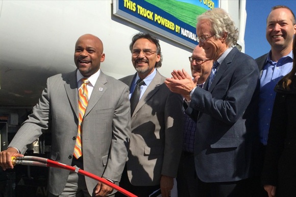 Mayor Hancock handles the "first fuel" at Denver's new CNG filling station.