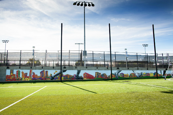 The complex features a colorful mural of the Denver skyline.