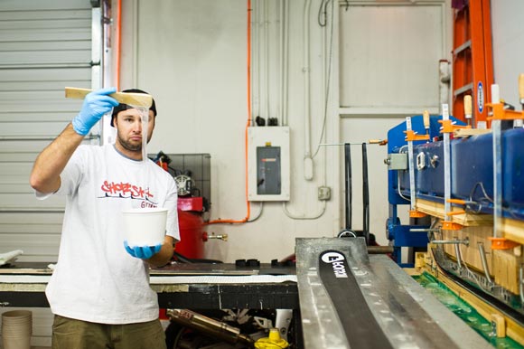 Mike McCabe checks the consistancy of the resin while making a pair of custom skis.