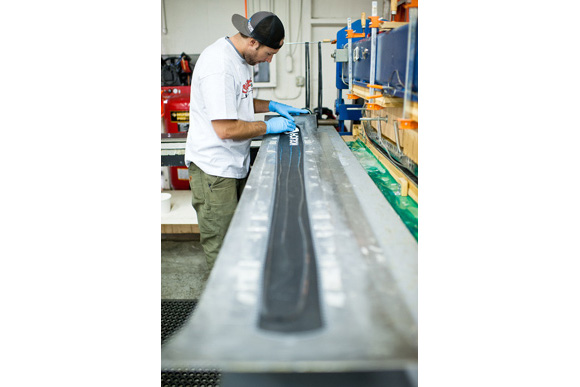 Mike McCabe massages in the resin all over the entire ski before it gets pressed and set.