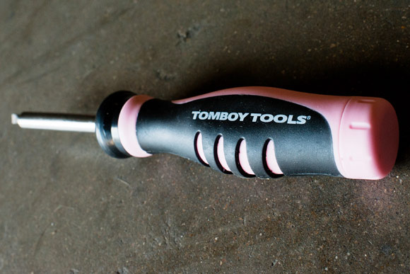 A close-up of the multi-bit ratchet screwdriver in their signature pink color by Tomboy Tools.