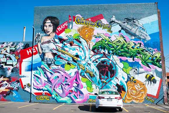 Large graffiti murals cover buildings in RiNo.