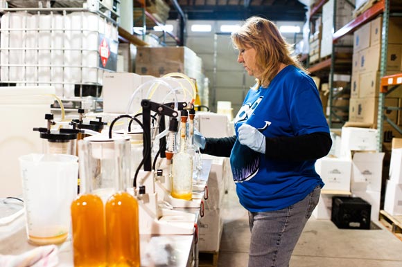 Barbara Klouse bottles Fireside Whiskey at Mile High Spirits in RiNo.