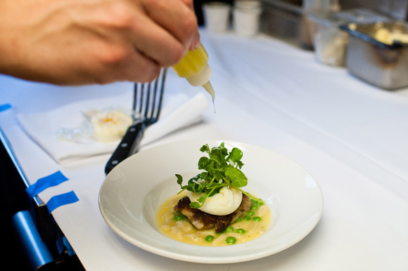 Fruition Restaurant's Chef de Cuisine, Matt Vawter, drizzles the finishing touch on the Pasta Carbonara.