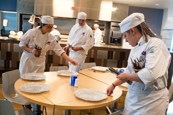 Students set the tables during the Food Production and Service 2 class. 
