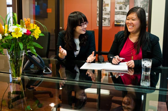 Helene Kwong goes over a University of Denver student's resume at Taopivot.