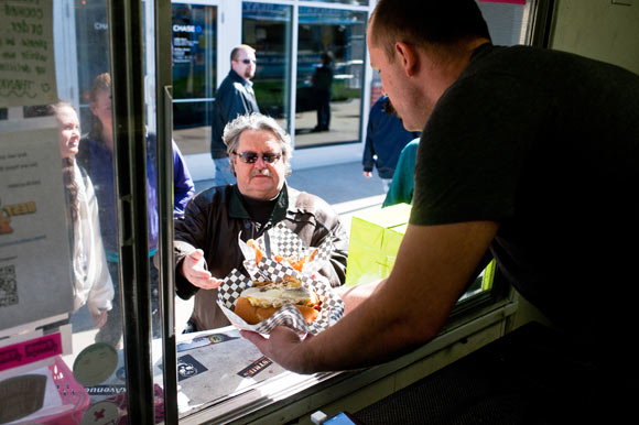 Pink Tank's David Mueller serves up dishes to a customer.