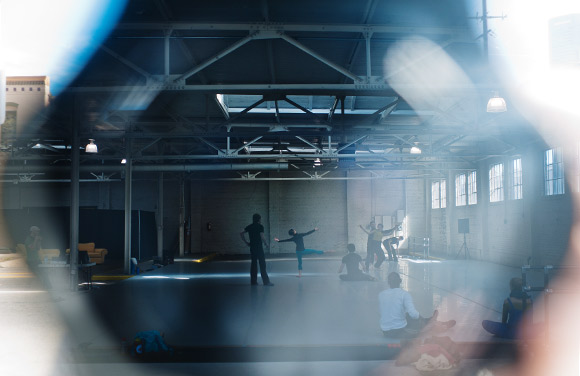 Viewing the dancers through a garage window from outside.