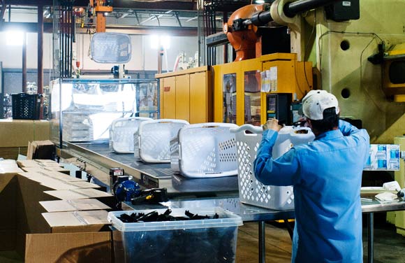 Handles are snapped into place on an assembly line at Intertech Plastics. 