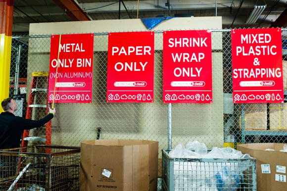 Jordan Lynch measures recycling signs.