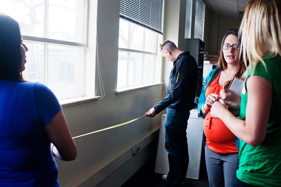 CSU Supply Chain Management students take measurements for recycling bins.