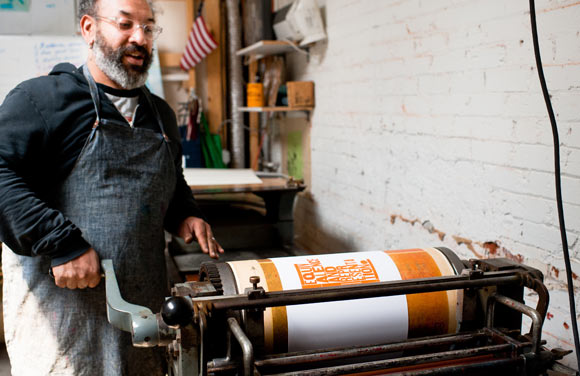 MATTER owner Rick Griffith runs the letterpress machine.