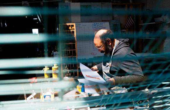 Rick Griffith studies a letterpress print.