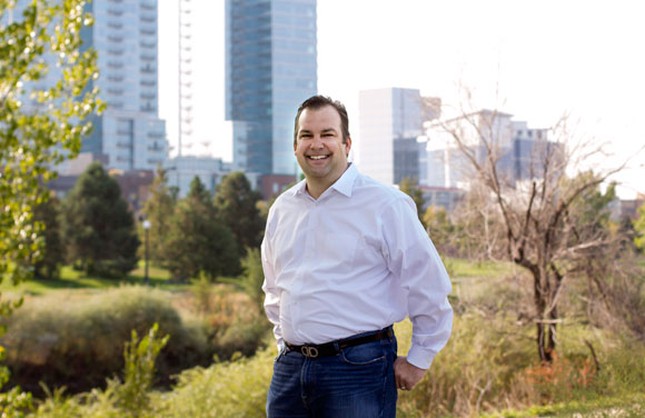 Erik Mitisek of the Colorado Technology Association and the Denver skyline.