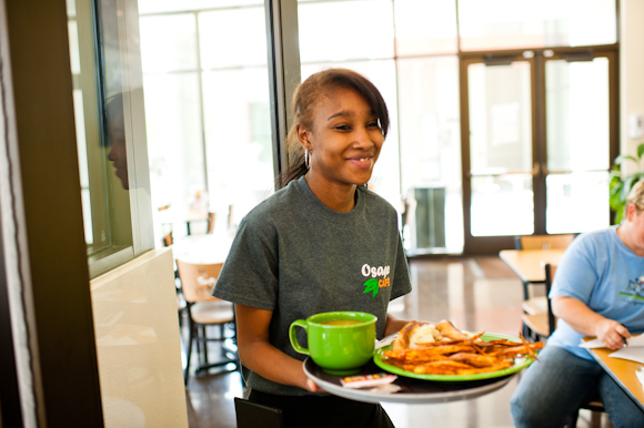 Taylor Alexander brings lunch to a table. 