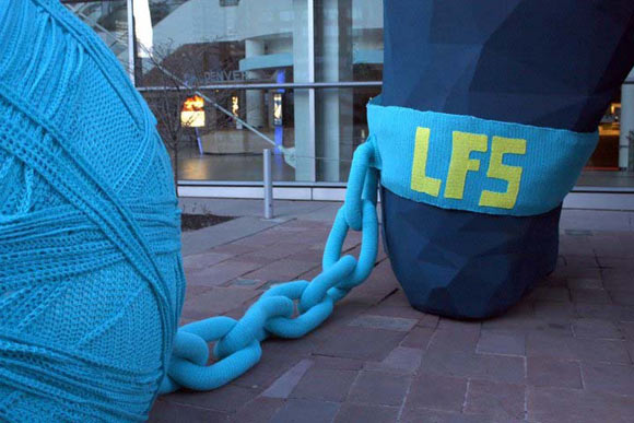 A large crocheted chain and ball of yarn on the famous Denver Sculpture "I See What You Mean" by Lawrence Argent.