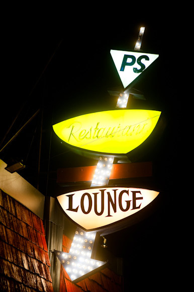 Neon signs decorate Colfax at night.