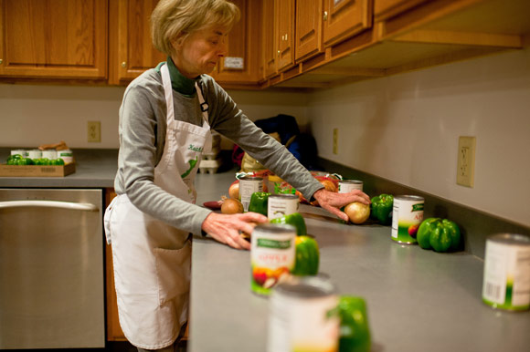 Volunteer Kathleen Busenbark groups together the groceries the cooking class participants will take home. 