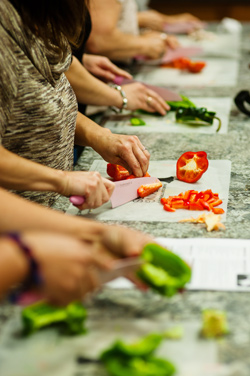 Participants learn various cooking techniques at Cooking Matters.