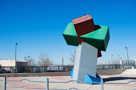 Shipping crate art sculpture on Broadway. The street is the demarcation between east and west street numbers in Denver.