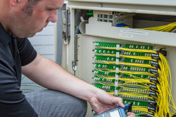 A CenturyLink Technocian installs optical fiber.