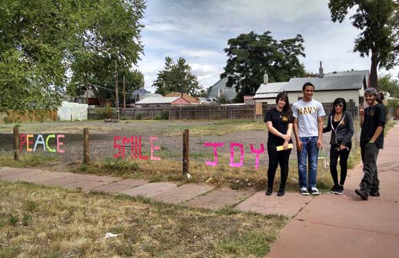 Arts Street participants install temporary fence art.