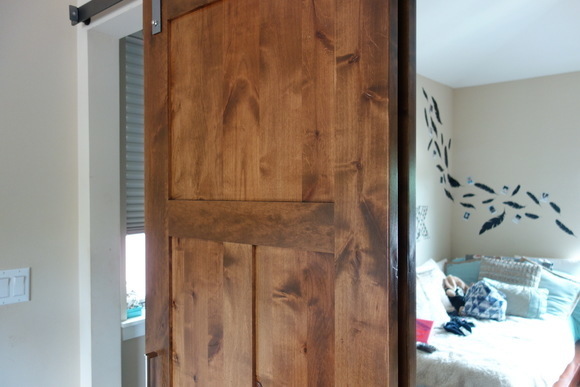 The barn door reveals a full-length mirror.