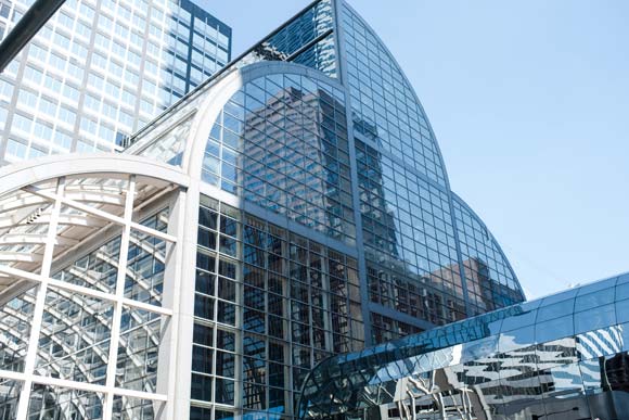 The tower resembles the cash register shape of the atrium across the street.