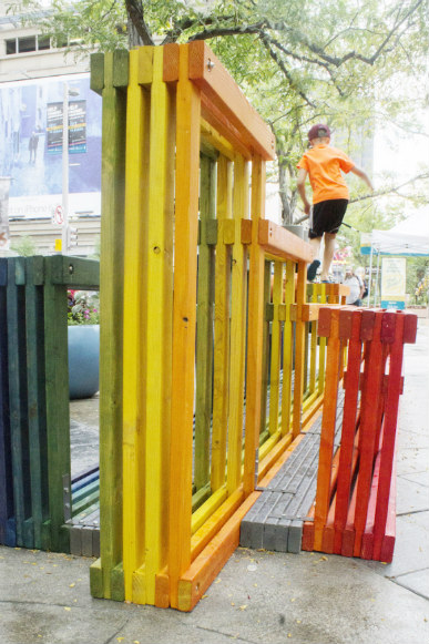 A kid finds another use for Rainbow Street Seating.