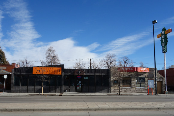 The Colorado Harvest Company is flanked by antiques and an old motel.