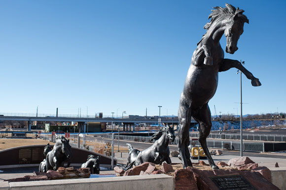 Statues of Broncos buck outside the stadium.