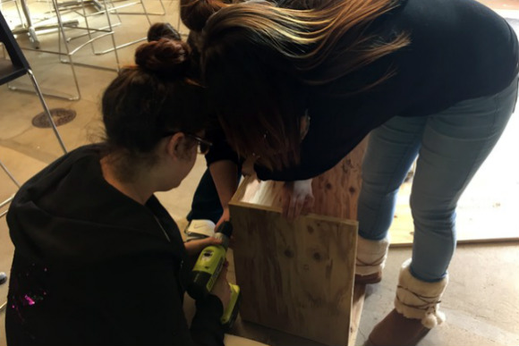 RiseUp students build a Little Free Library.