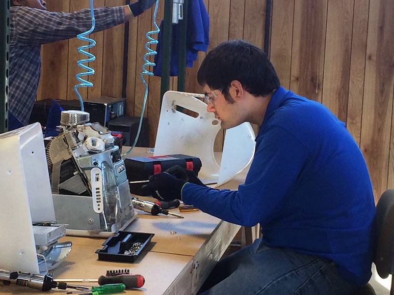 A Blue Star Recyclers employee works on a computer.