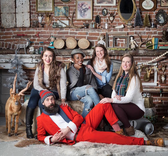 Hipster Claus poses with girls.