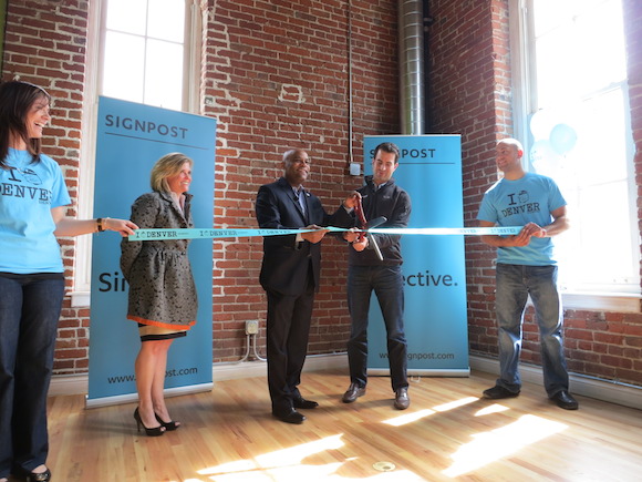 Signpost CEO Stuart Wall cuts the ribbon.